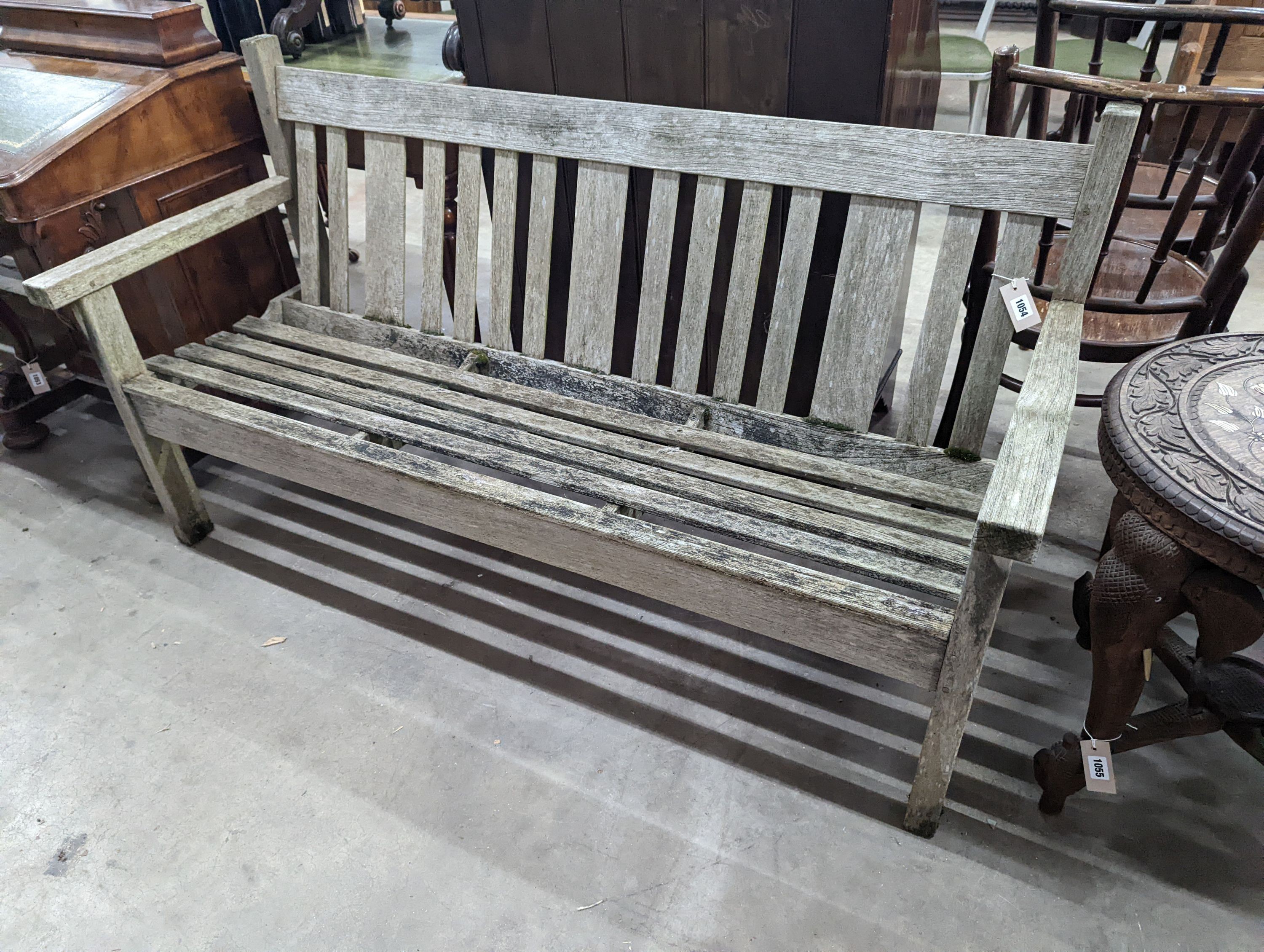 A weathered teak garden bench, length 158cm, depth 62cm, height 84cm